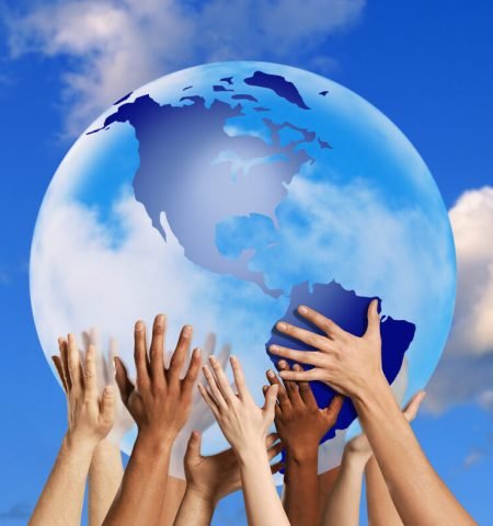 Hands touching a globe --- Image by © Royalty-Free/Corbis